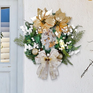 Christmas wreath with golden poinsettia white berries and Nativity scene center