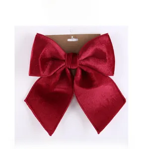 Front view of large red velvet bow on a kraft card for Chinese New Year festive decor