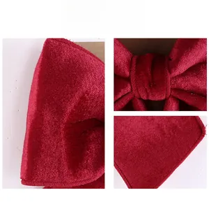 Detailed close-up of dark red velvet bow with premium texture and refined stitching