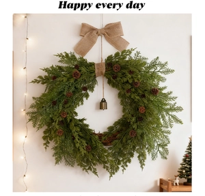 Detail of Christmas wreath with pine cones, burlap bow, and vintage bell on a white wall