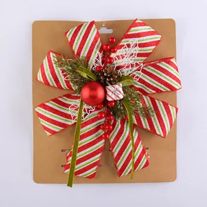 Detail of Christmas ribbon bow with pine cone berries and striped glitter finish on card