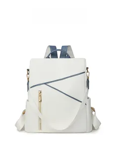 Close-up of ivory white nylon backpack with geometric stitching and gold metal zippers