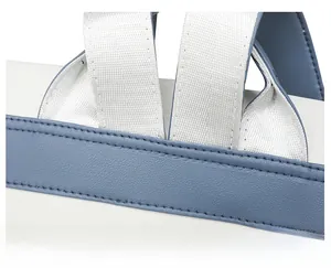 Detailed view of reinforced stitching on durable blue leather and white canvas strap