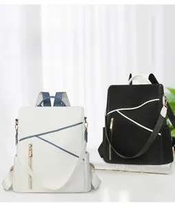 Detail of minimalist waterproof nylon backpacks in black and beige with geometric patterns