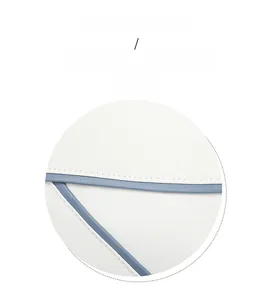 Detail of the high-quality white leather backpack with blue contrast stitching and trim