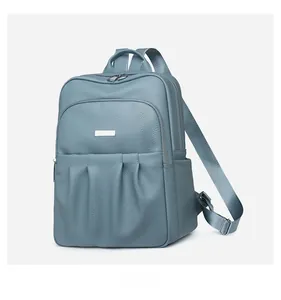 Detailed side view of Morandi blue Oxford backpack with leather texture and zip pocket