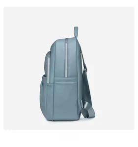 Side view of blue oxford backpack showing spacious side pocket and silver zippers