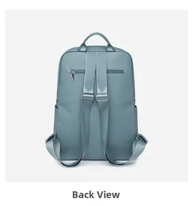 Back view of Morandi blue Oxford backpack featuring adjustable straps and rear zipper pocket