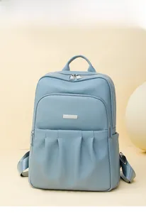 Detail view of the Morandi blue Oxford backpack featuring textured pleats and side pockets