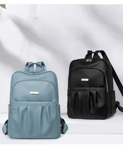 Close-up of minimalist oxford fabric backpacks in sky blue and black with pebble texture