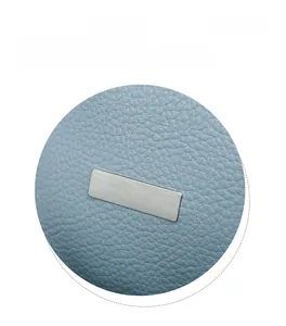 Detail display of light blue oxford fabric texture with a rectangular metal buckle plaque