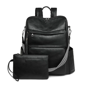 Detail of black faux leather backpack set with tassel and geometric woven shoulder strap