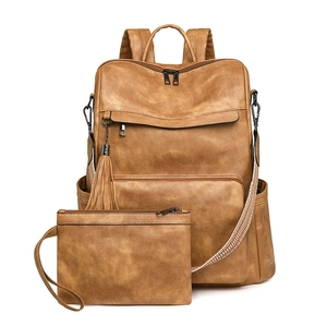 Close-up of vintage brown leather backpack set with woven strap and matching pouch