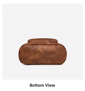 Detailed bottom view of the vintage brown leather backpack showing smooth stitching