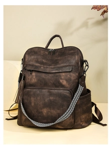 Detailed texture of retro dark brown water-washed PU leather on professional laptop backpack