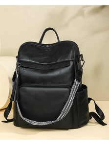 Detail of black pebbled leather laptop backpack with a woven black and white shoulder strap