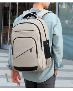 Rear view of a minimalist beige travel backpack with ergonomic breathable shoulder straps