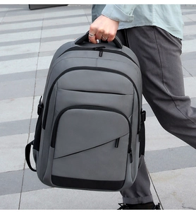 Close-up of a durable grey business commute backpack with reinforced black base and side buckles
