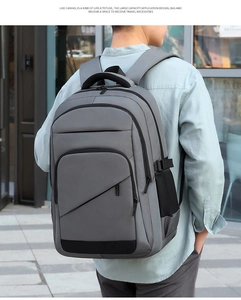 Macro view of water-resistant fabric and multi-layer zipper pockets on a gray backpack