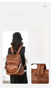 Detail showing multi-way carrying options for the vintage brown leather backpack for women