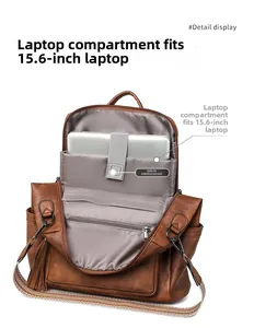 Detail view of the 15.6-inch laptop compartment with velcro strap in a brown backpack