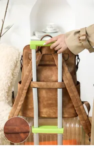 Brown leather laptop backpack with a trolley sleeve for easy travel convenience
