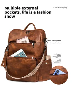 Detail view of brown faux leather backpack with woven strap and organized inner pockets