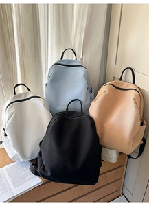 Vier minimalistische Rucksäcke mit Textur in Weiß, Blau, Schwarz und Beige in der Ansicht