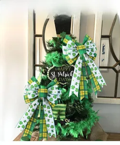 Detail of St. Patrick's Day bow with clover pattern and green plaid on a festive wreath