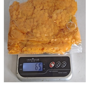 Detailed view of 65g orange artificial marigold petals in transparent packaging for festivals