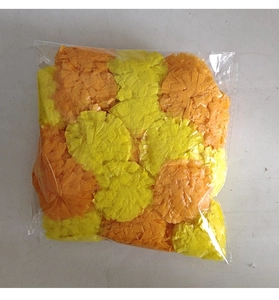 Macro shot of orange and yellow artificial marigold garlands in transparent packaging