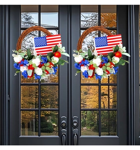 Patriotic door wreaths with red white blue flowers and American flag on black doors