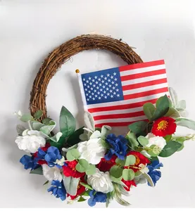 Detail of Fourth of July wreath with red white blue flowers and small US flag on rattan