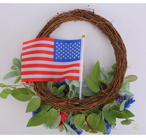 Close-up of patriotic wreath with rattan base, silk flowers, and a small American flag