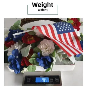 Weight display of Fourth of July wreath with roses and American flag on a digital scale