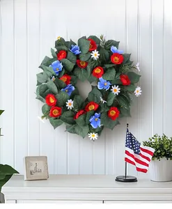 Detail of red white and blue artificial wreath with patriotic flowers on white wall