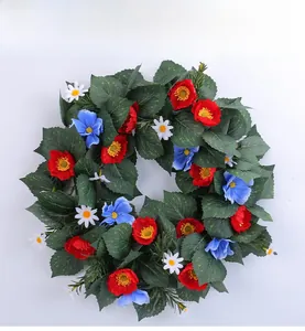 Detailed view of patriotic wreath with red and blue flowers on natural vine base