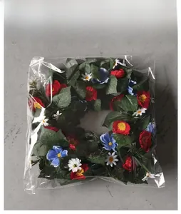 Detailed view of the red, white and blue floral wreath in clear protective packaging