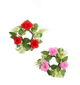 Detailed view of artificial rose wreaths in red and pink for candle cup decoration