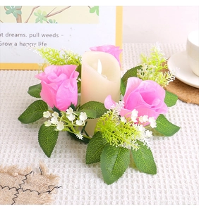 Close-up of pink artificial rose wreath with LED candle on a white checkered tabletop