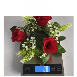 Weight measurement of a simulation rose candle ring wreath showing 28g on a digital scale