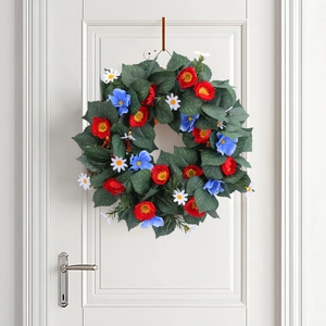 Patriotic Independence Day wreath with red blue and white flowers on a white door