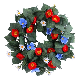 Independence Day wreath with red and blue flowers on green leaves for door decor