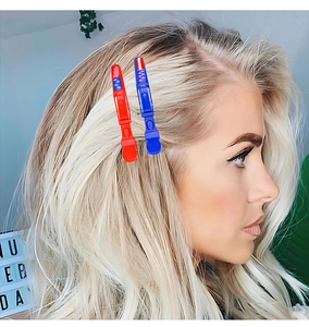 Detail of red and blue Independence Day star hair clips worn as side decorative accessories