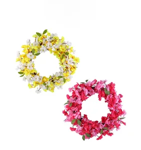 Detail of yellow and pink artificial flower wreaths for wall and door decoration