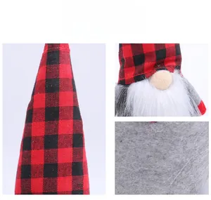 Detail of red and black buffalo plaid gnome hat with white plush beard and felt base