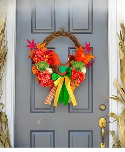 Close-up of fall wreath with turkey plush, maple leaves, and pumpkin on gray door