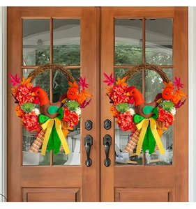 Detail of fall door wreath with plush chicken, maple leaves and pumpkin accents