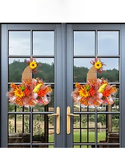 Detail of fall harvest door wreath featuring sunflower, burlap bow and plush gnome decor