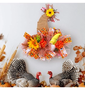 Close-up of autumn harvest wreath with mesh gnome, sunflowers and plaid ribbons